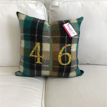 Load image into Gallery viewer, Felted Wool Blanket Pillow - Chocolate brown, red, green, cream plaid background with leafy mustard numbers and green check CN Tower. Incorporates the blanket fringe as soft adornment on front
