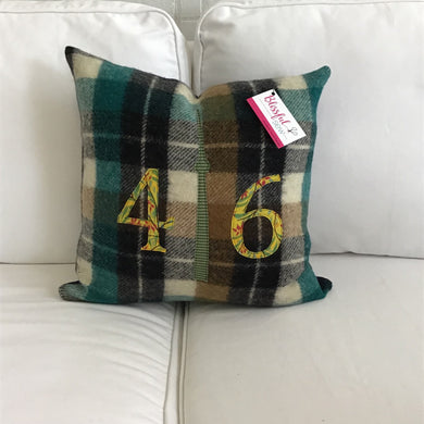 Felted Wool Blanket Pillow - Chocolate brown, red, green, cream plaid background with leafy mustard numbers and green check CN Tower. Incorporates the blanket fringe as soft adornment on front