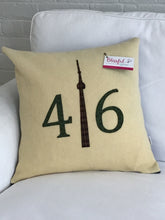 Load image into Gallery viewer, Wool Blanket Pillow - Cream colored background with moss green numbers and green/brown plaid CN Tower.
