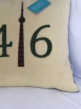 Load image into Gallery viewer, Cream colored pillow with green numbers and check CN Tower.
