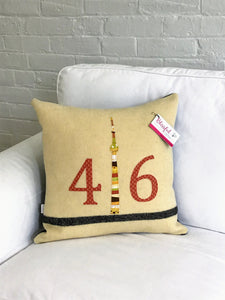 Cream pillow with modern black stripe. Rust numbers and coordinating CN Tower