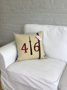 Cream pillow with modern black stripe. Red plaid numbers and black CN Tower.