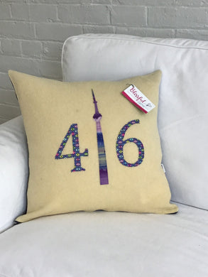 Felted Wool Blanket Pillow - Cream colored background with pretty purple, lime, pink eye numbers and purple batik CN Tower.