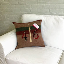 Load image into Gallery viewer, Felted Wool Blanket Pillow - Light brown background with thick maroon and moss green stripes. maroon plaid numbers and cream/brown CN Tower.
