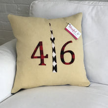 Load image into Gallery viewer, Cream pillow with modern red plaid numbers and black CN Tower.
